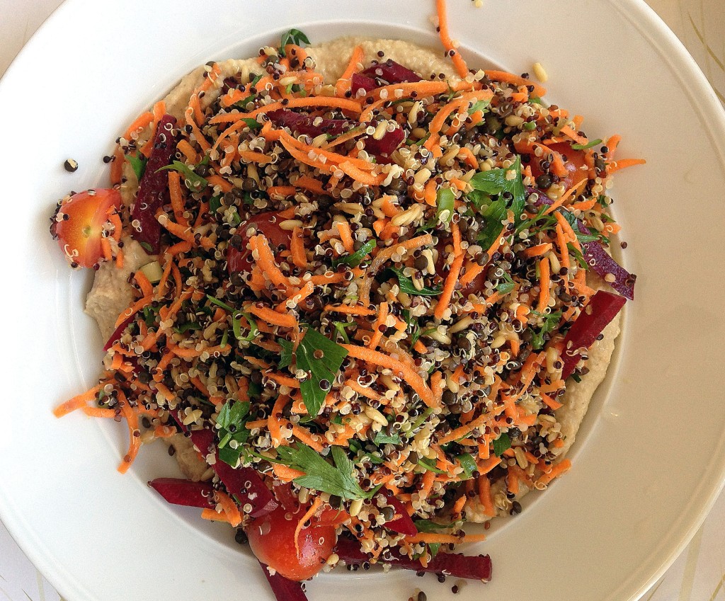 Salad with quinoa, chia seeds, beets, carrots, tomatoes, oats, lentils, and other goodies over hummus and tahini at Cafe Louse in Haifa (http://www.cafelouise.co.il/warehouse/userUploadFiles/file/58-1028_Menu_CafeLouise_Zohoraim_Erev_Eng.pdf)